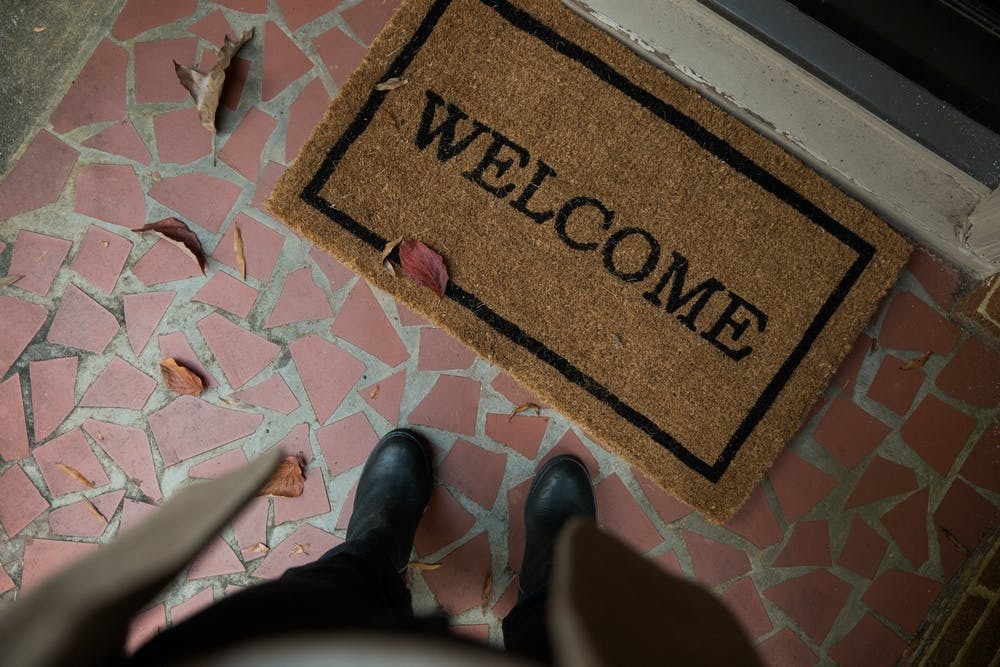 Feet at a welcome doormat